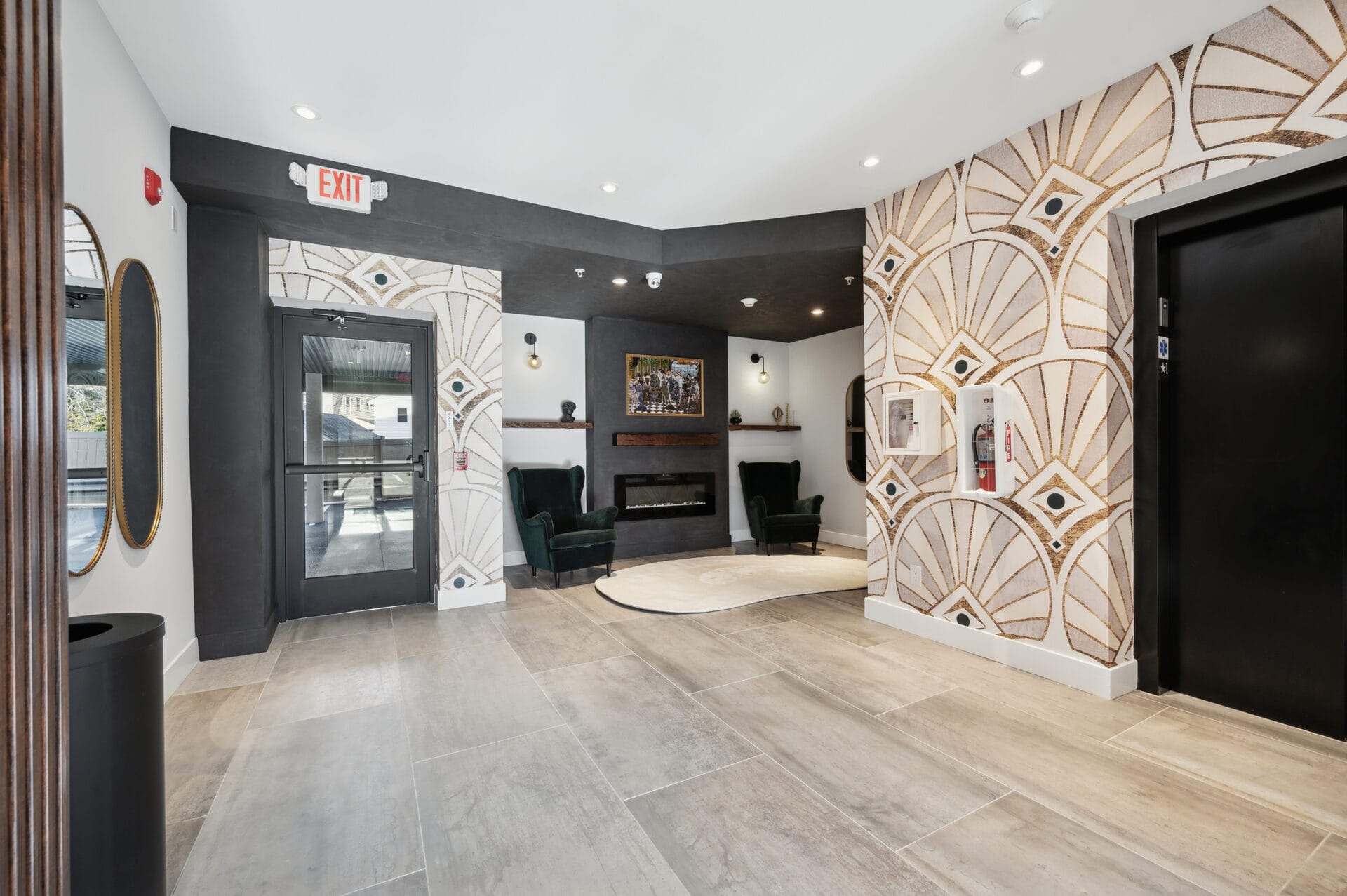 The Lane Jenkintown lobby fireplace seating area with velvet wingback chairs and curated artwork